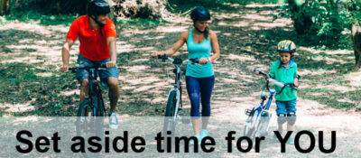 Cheerful family biking in park